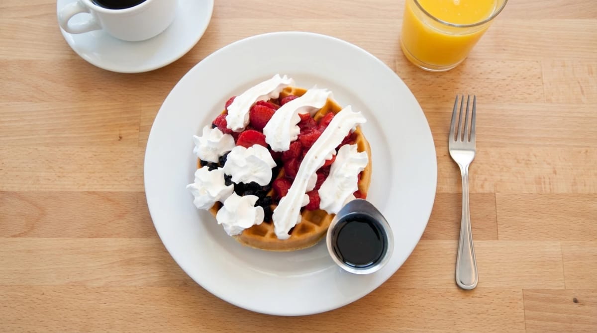 U.S. Egg Red, White & Blue Waffle โ a Belgian waffle topped with fresh blueberries, strawberries, and whipped cream
