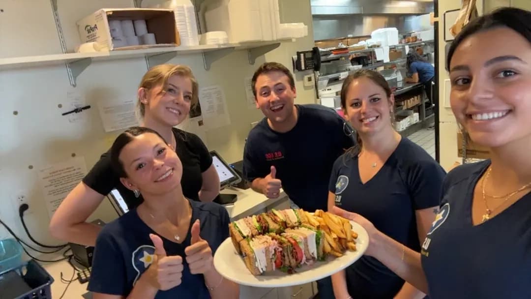 Team celebrating successful sandwich service